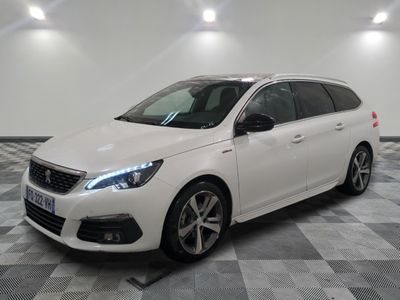 the white car is parked on a checkered floor in the garage