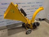 a close up of a small yellow machine with wheels on the ground