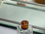 a glass tray with a brush, comb, and soap bottle on it