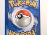 a pokemon card with a red and white ball on it
