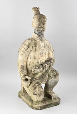 an image of a statue of a man sitting on top of a stone block