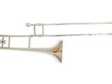 pair of brass trombones on a white background