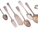 a lot of spoons and forks that are on the table