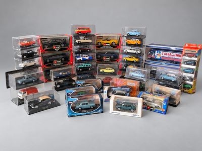 a lot of toy cars in a display case on a table