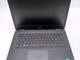 a dell laptop computer sitting on a white surface