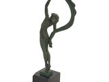 bronze statue of a woman holding a circular object on a marble base