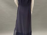 the back view of a mannequin dress with fringes on a mannequin base