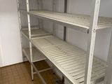 a white shelf with shelves on it in a room