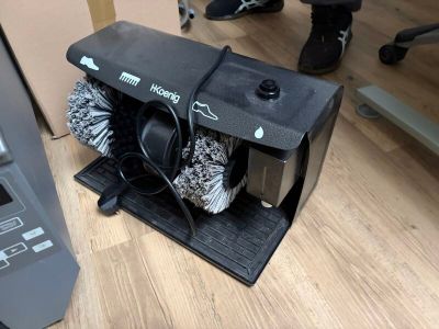 a machine that is sitting on the floor next to a laptop