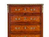 an antique chest of drawers with a wooden top and brass hardware