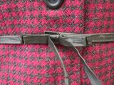 a close up of a woman ' s coat with a belt