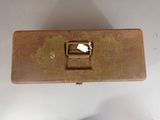 a brown metal box with a light on top of it