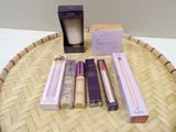 a lot of makeup products sitting on a wicker tray