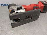 a close up of a red and black electric tool on a table