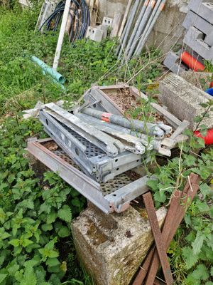 a pile of junk sitting in the grass next to a building