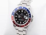 a rolex watch with a red, white, and blue bezel