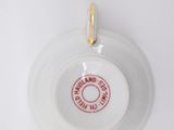 a white plate with a red stamp on it