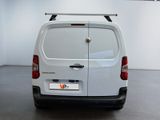 a white van parked in a room with a white wall