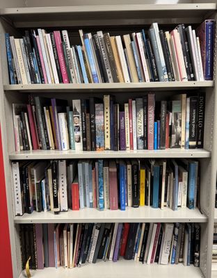 a book shelf with many books on it in a library