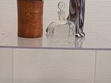 a glass shelf with various glass objects on it