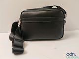 a small black bag with a strap on it
