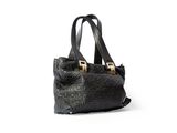 a black handbag with gold handles on a white background