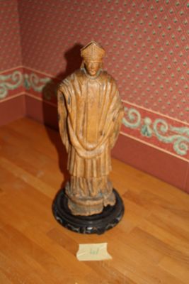 a statue of a man standing on a wooden floor