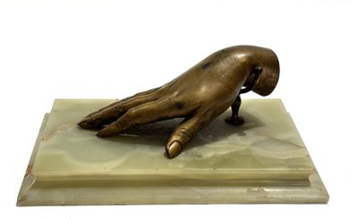 bronze statue of a hand resting on a marble base