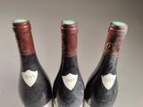 three bottles of wine sitting next to each other on a table