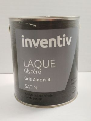 a can of paint sitting on a white surface