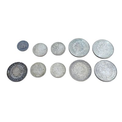 many different types of coins on a white surface