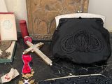 a purse and other items on a table next to a cross