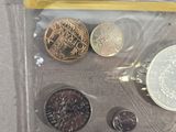 a bag of coins and a pen on a table