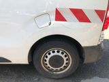 a white van with red and white stripes parked in a parking lot