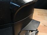 a black toaster sitting on top of a wooden table