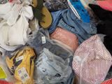 a suitcase full of clothes and shoes on the floor
