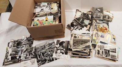 a box full of old black and white photos on a table