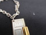 a silver and gold cell phone on a silver chain