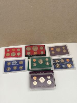 several different types of coins are sitting on a table
