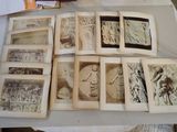 a lot of old books on a table with pictures on them