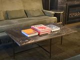 a couch and a table in a room with a fireplace