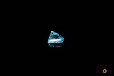 a close up of a blue diamond on a black background