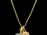 a gold heart and pearl pendant on a chain