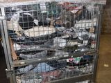 a metal cart with many items in it in a warehouse