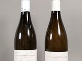 two bottles of wine sitting next to each other on a table