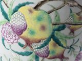 a vase with a painting of fruit and flowers on it