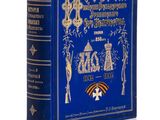 un vieux livre avec une couverture bleue et des lettres dorées