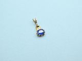 an image of a small blue and white diamond pendant on a blue surface