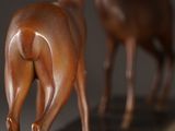 two statues of a horse that are standing next to each other