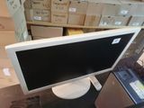 a computer monitor sitting on top of a desk in front of boxes